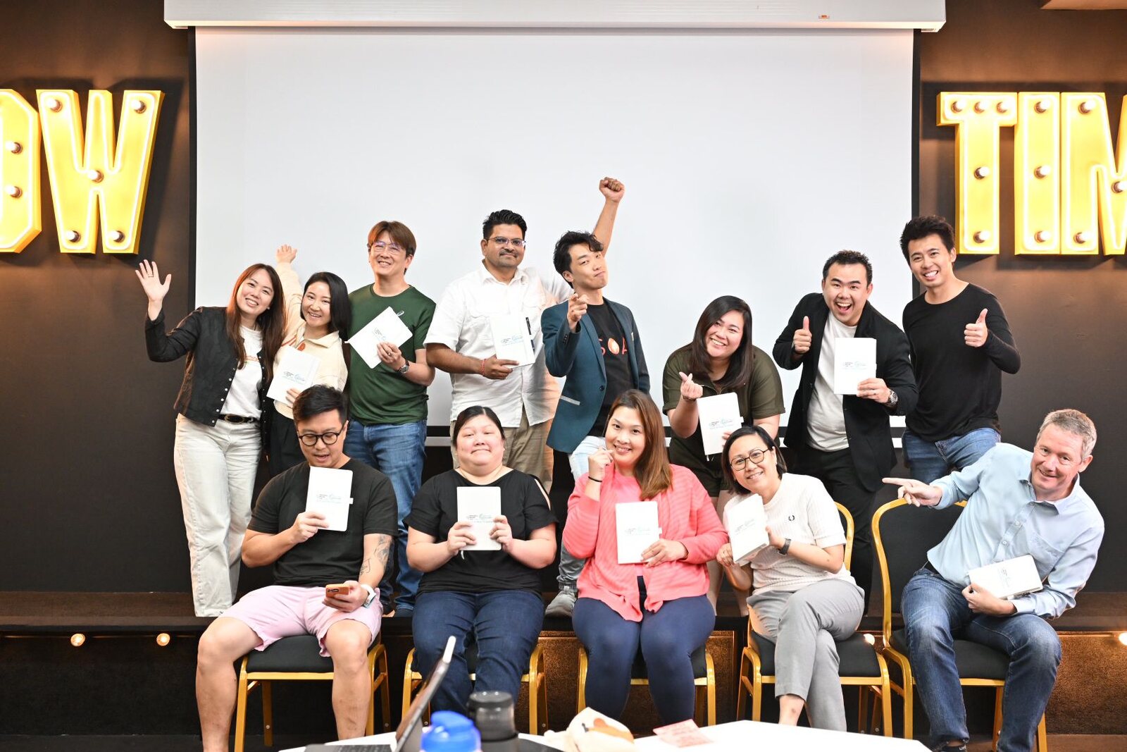 Participants holding completed workshop materials